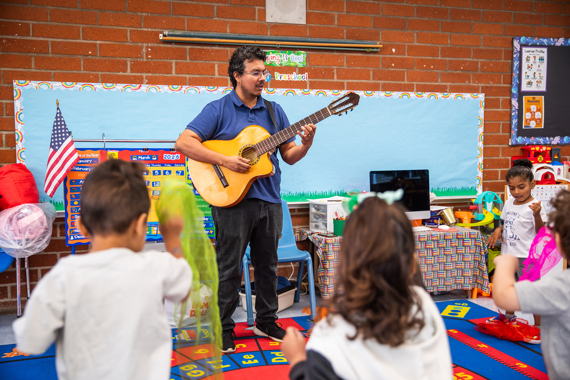 GPS student playing guitar in music class